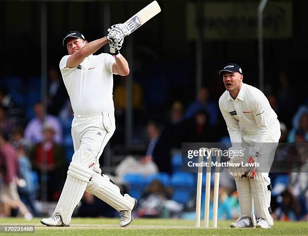 David Saker of Shane Warne's Australia hits a six, as Paul Nixon of Michael Vaughan;s England looks on during the Shane Warne's Australia vs Michael...