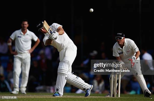 Michael Vaughan, captain of Michael Vaughan's England hits a six, as Ian Harvey of Shane Warne's Australia looks on during the Shane Warne's...