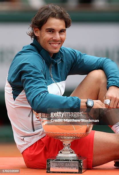 Rafael Nadal of Spain poses with the Coupe des Mousquetaires trophy as he celebrates victory in the men's singles final against David Ferrer of Spain...