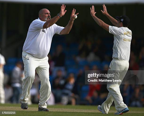 Damien Martyn of Shane Warne's Australia congratulates Merv Hughes, after he caught and bowled Jeremy Snape of Michael Vaughan's England during the...