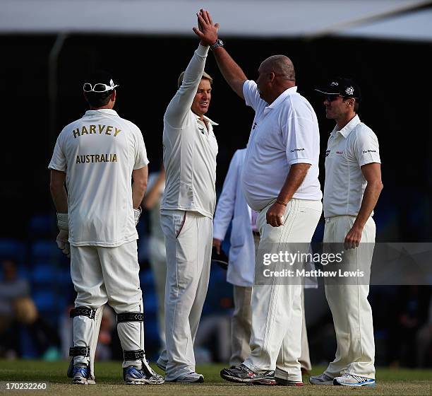Shane Warne, captain of Shane Warne's Australia congratulates Merv Hughes, after he caught and bowled Jeremy Snape of Michael Vaughan's England...