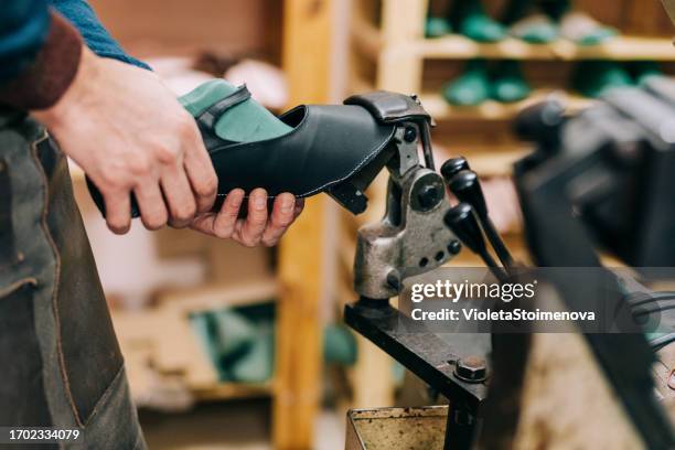 jeune cordonnier dans l’atelier. - magasin de chaussures photos et images de collection