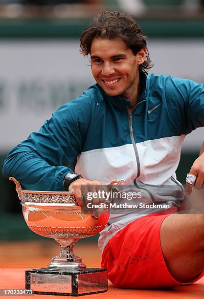 Rafael Nadal of Spain poses with the Coupe des Mousquetaires trophy as he celebrates victory in the men's singles final against David Ferrer of Spain...