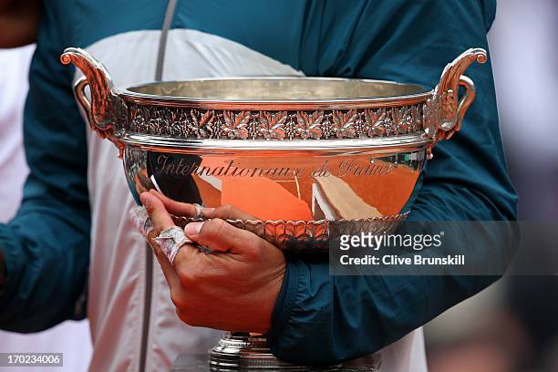 Detailed view as Rafael Nadal of Spain celebrates victory with the Coupe des Mousquetaires trophy in the men's singles final against David Ferrer of...