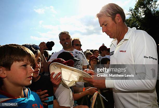 Shane Warne, captain of Shane Warne's Australia signs autographs after the Shane Warne's Australia vs Michael Vaughan's England T20 match at...