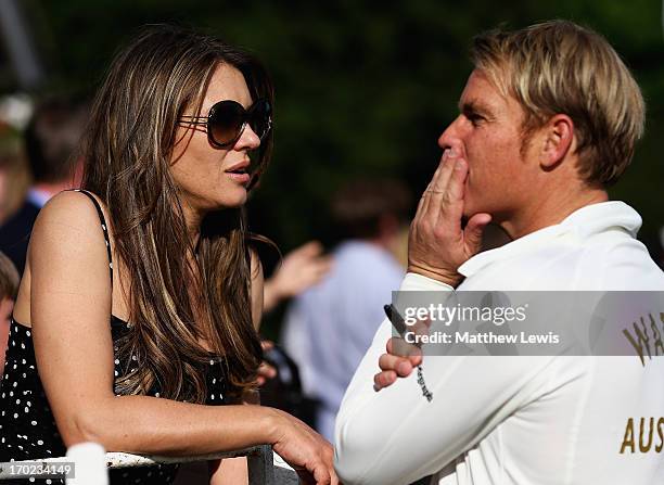 Elizabeth Hurley and Shane Warne look on during the Shane Warne's Australia vs Michael Vaughan's England T20 match at Circenster Cricket Club on June...