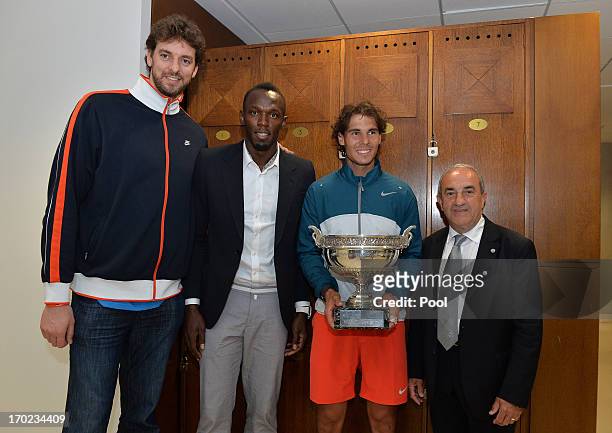Rafael Nadal of Spain, Usain Bolt and Paul Gasol pose in the locker room with the Coupe des Mousquetaires trophy after the men's singles final...