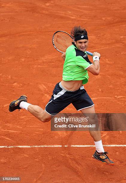David Ferrer of Spain plays a forehand during the Men's Singles final match against Rafael Nadal of Spain during day fifteen of the French Open at...
