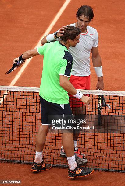 Rafael Nadal of Spain embraces David Ferrer of Spain at the net after the Men's Singles final match on day fifteen of the French Open at Roland...