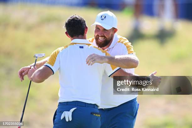Shane Lowry and Rory McIlroy of Team Europe interact on the 18th green after finishing their practice round prior to the 2023 Ryder Cup at Marco...