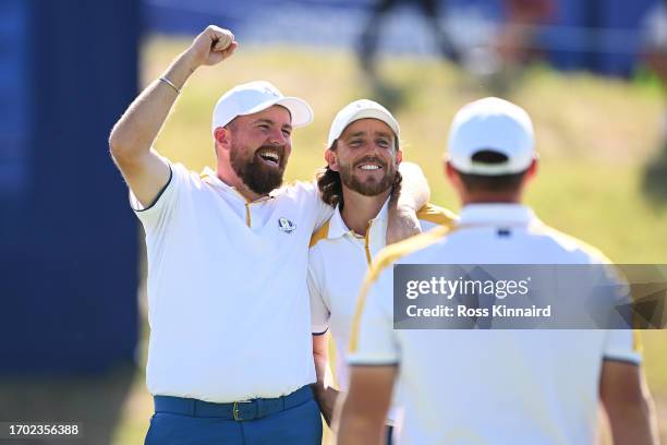 Shane Lowry and Tommy Fleetwood of Team Europe react on the 18th green after finishing their practice round prior to the 2023 Ryder Cup at Marco...