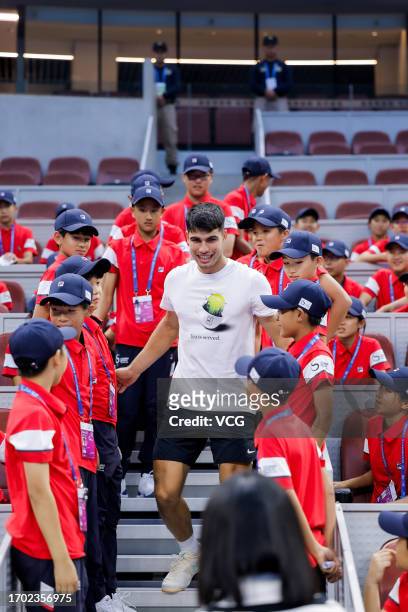 Carlos Alcaraz of Spain meets ball boys on day one of 2023 China Open at the National Tennis Center on September 26, 2023 in Beijing, China.