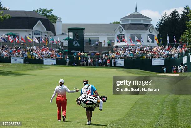 Inbee Park of South Korea walks with her caddie Brad Beecher on the 18th hole during the weather-delayed third round of the Wegmans LPGA Championship...