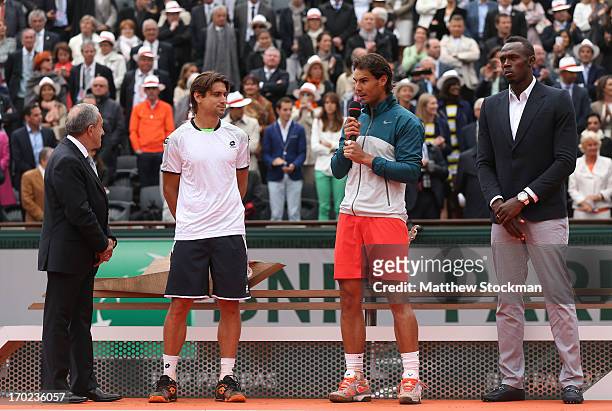 Rafael Nadal of Spain speaks to the crowd next to David Ferrer of Spain, Olympic champion Usain Bolt and President of the International Tennis...