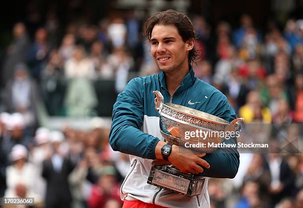 Rafael Nadal of Spain poses with the Coupe des Mousquetaires trophy as he celebrates victory in the men's singles final against David Ferrer of Spain...