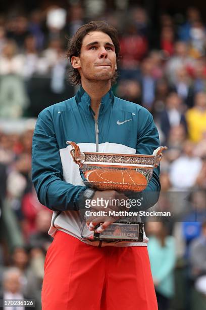 Rafael Nadal of Spain poses with the Coupe des Mousquetaires trophy as he celebrates victory in the men's singles final against David Ferrer of Spain...
