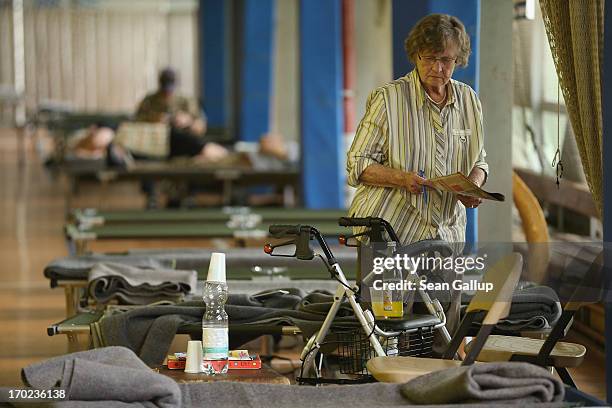 Brigitte Ilsmann prepares to read a magazine in an evacuation center administered by the German Red Cross for people forcred to flee their homes due...