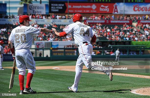 Mark Trumbo of the Los Angeles Angels of Anaheim celebrates with teammate Brendan Harris after hitting a homerun in the fourth inning against the...