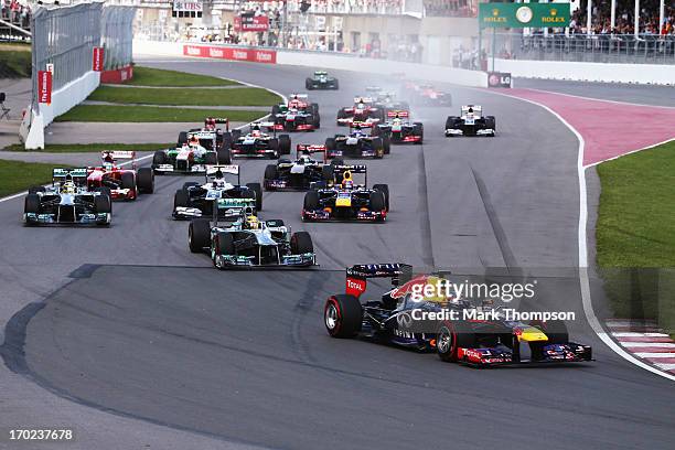 Sebastian Vettel of Germany and Infiniti Red Bull Racing leads the field into turn one at the start of the Canadian Formula One Grand Prix at the...