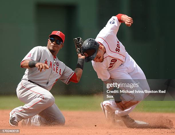 Jacoby Ellsbury of the Boston Red Sox slides underneath the tag of Erick Aybar of the Los Angeles Angels for a stolen base in the third inning on...