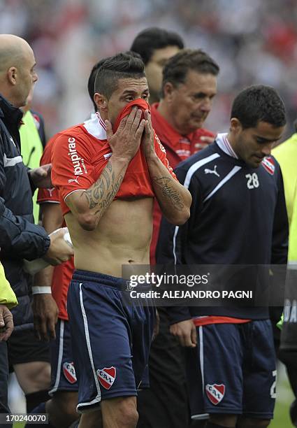 Independiente's defender Cristian Tula reacts after they lost by 2-1 against River Plate during their Argentine First Division football match, at the...