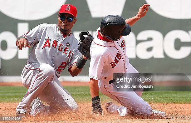 Jacoby Ellsbury of the Boston Red Sox steals second base as Erick Aybar of the Los Angeles Angels takes a late throw in the 3rd inning at Fenway Park...