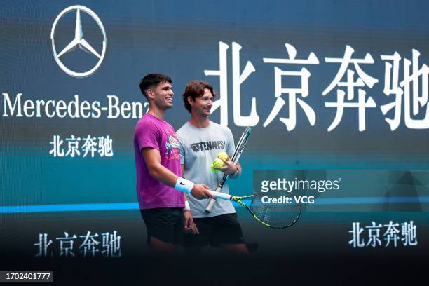 Carlos Alcaraz of Spain and his coach Juan Carlos Ferrero attend a training session on day one of 2023 China Open at the National Tennis Center on...