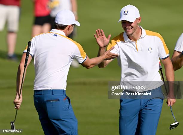 Matt Fitzpatrick and Nicolai Hojgaard of Team Europe interact during a practice round prior to the 2023 Ryder Cup at Marco Simone Golf Club on...