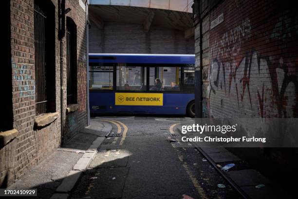 Bee Network bus makes its way through Manchester city centre on September 26, 2023 in Manchester, England. The new publicly-owned bus network is...