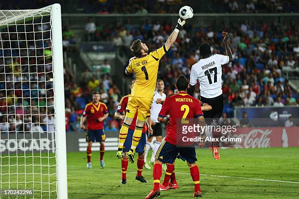 Goalkeeper David de Gea of Spain clears the ball ahead of Antonio Ruediger of Germany during the UEFA European U21 Champiosnship Group B match...