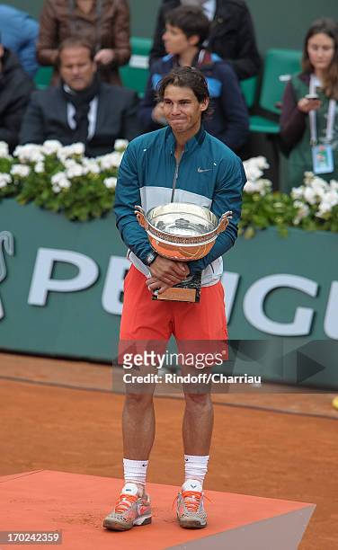 Rafael Nadal poses with the trophy of Musketeers after he wins the french open 2013 at Roland Garros on June 9, 2013 in Paris, France.