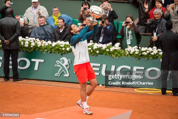 Rafael Nadal poses with the trophy of Musketeers after he wins the french open 2013 at Roland Garros on June 9, 2013 in Paris, France.