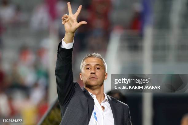 Duhail's Argentine coach Hernan Crespo speaks to his players during the AFC Champions League Group E football match between Qatar's Al-Duhail and...