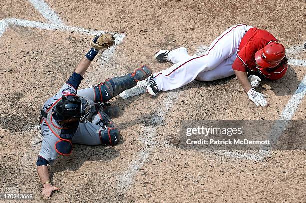 Ryan Doumit of the Minnesota Twins shows home plate umpire Chris Conroy the ball after tagging out Jayson Werth of the Washington Nationals at home...