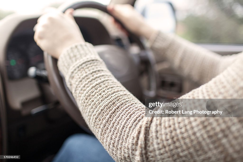 Driving, hands on a car  steering wheel