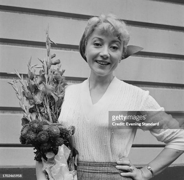 French actress Colette Brosset holding a bouquet, September 19th 1958.