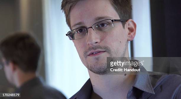 In this handout photo provided by The Guardian, Edward Snowden speaks during an interview in Hong Kong. Snowden, a 29-year-old former technical...