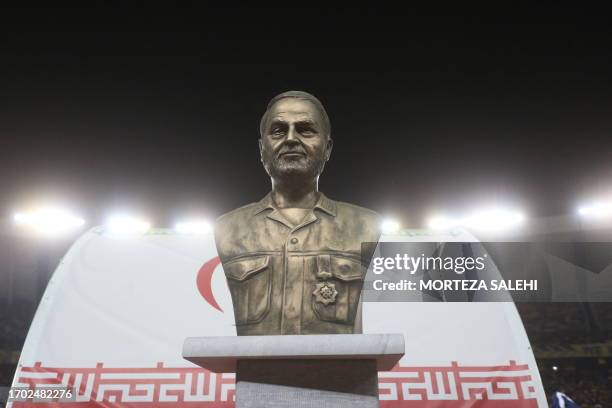 Bust of slain Iranian Revolutionary Guards commander Qasem Soleimani is displayed before the pitch at the Naghsh-e-Jahan Stadium in Isfahan during...