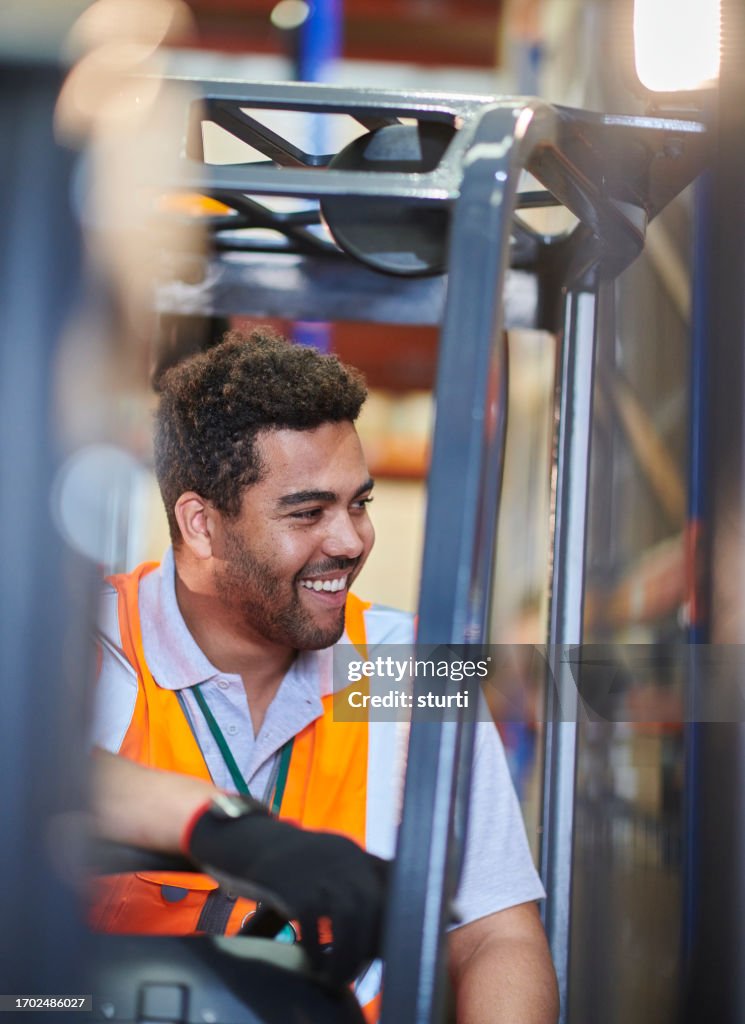 Fork lift truck driver in a warehouse
