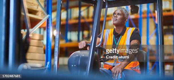 female fork lift operator loading - garment factory stock pictures, royalty-free photos & images