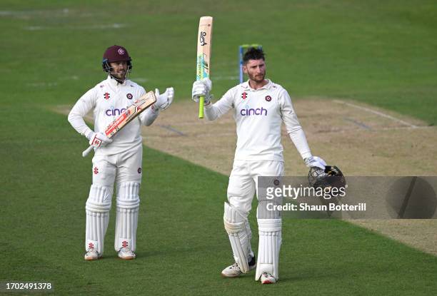 Rob Keogh of Northamptonshire is applauded by teammate Lewis McManus after reaching his 100 during the LV= Insurance County Championship Division 1...