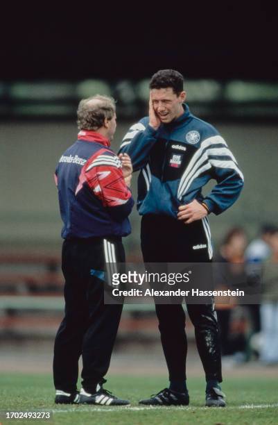 German football manager Berti Vogts, manager of the German national team, in conversation with South Africa-born German footballer Sean Dundee during...