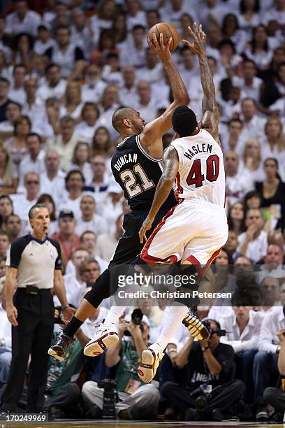 Tim Duncan of the San Antonio Spurs goes up for a shot over Udonis Haslem of the Miami Heat in the first quarter during Game Two of the 2013 NBA...