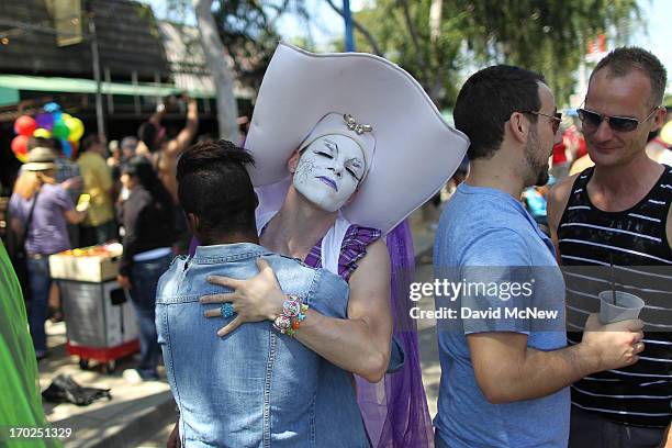 Member of the Sisters of Perpetual Indulgence, who dress as "queer nuns," receives a hug at the 43rd L.A. Pride Parade on June 9, 2013 in West...