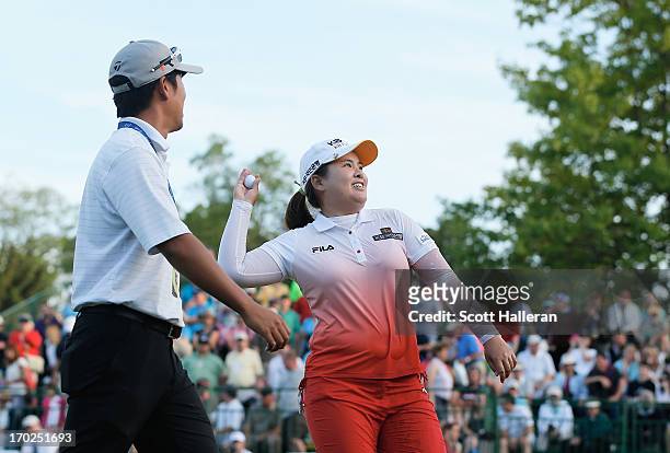 Inbee Park of South Korea celebrates after defeating Catriona Matthew on the third playoff hole alongside her coach and fiance, Gihyeob Nam during...