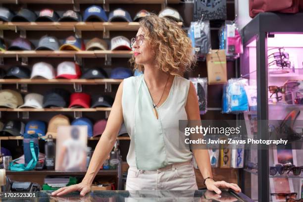 woman working in clothes shop, portrait. - fashion store staff stock pictures, royalty-free photos & images