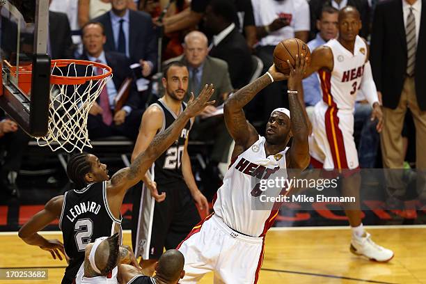 LeBron James of the Miami Heat shoots over Kawhi Leonard of the San Antonio Spurs in the first half during Game Two of the 2013 NBA Finals at...