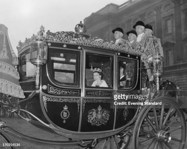 Queen Elizabeth II in the traditional Irish State Coach travelling to Westminster for her first State Opening of Parliament as the crowned sovereign,...