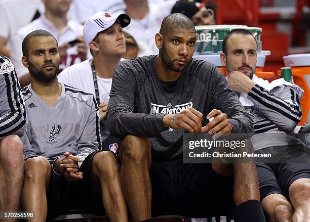 Tony Parker, Tim Duncan and Manu Ginobili of the San Antonio Spurs sit on the bench late in the fourth quarter while taking on the Miami Heat during...