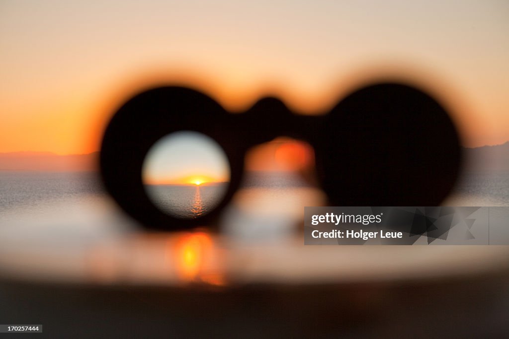 Sunset through binoculars from cruise ship
